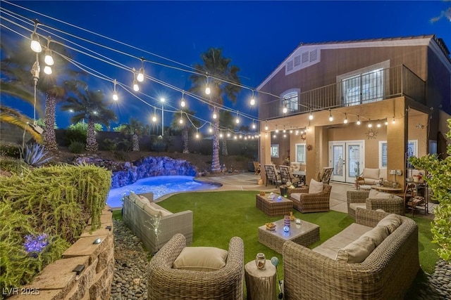 1246 Diamond Valley St, Henderson, NV 89052 - yard at night with a balcony, french doors, an outdoor hangout area, a patio area, and an outdoor pool