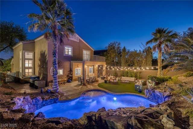 1246 Diamond Valley St, Henderson, NV 89052 - pool at twilight featuring an outdoor living space, a patio area, and a fenced backyard