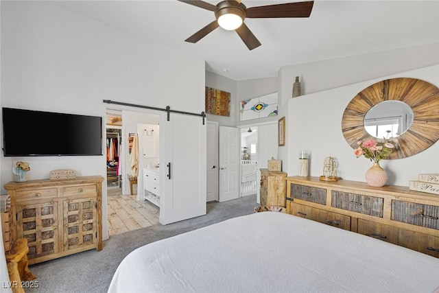 1246 Diamond Valley St, Henderson, NV 89052 - carpeted bedroom featuring a barn door, a high ceiling, ensuite bath, a walk in closet, and ceiling fan