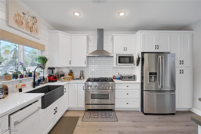 1246 Diamond Valley St, Henderson, NV 89052 - kitchen featuring stainless steel appliances, wall chimney range hood, decorative backsplash, light countertops, and white cabinets