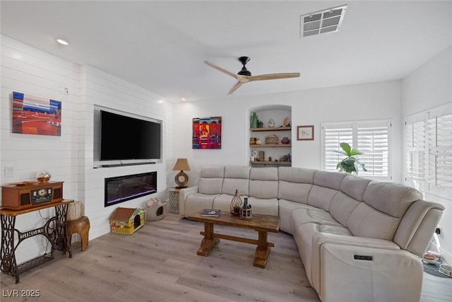 1246 Diamond Valley St, Henderson, NV 89052 - living room with ceiling fan, wood finished floors, built in shelves, and recessed lighting