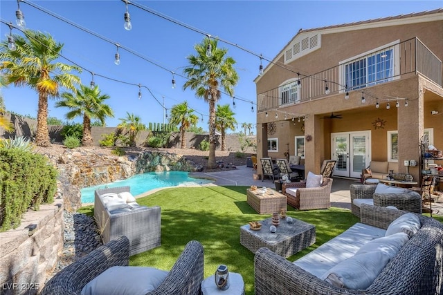 1246 Diamond Valley St, Henderson, NV 89052 - fenced backyard featuring a balcony, french doors, an outdoor hangout area, and a patio