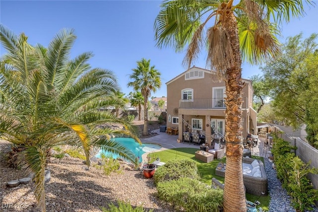 1246 Diamond Valley St, Henderson, NV 89052 - back of property with a balcony, stucco siding, a fenced backyard, and a patio