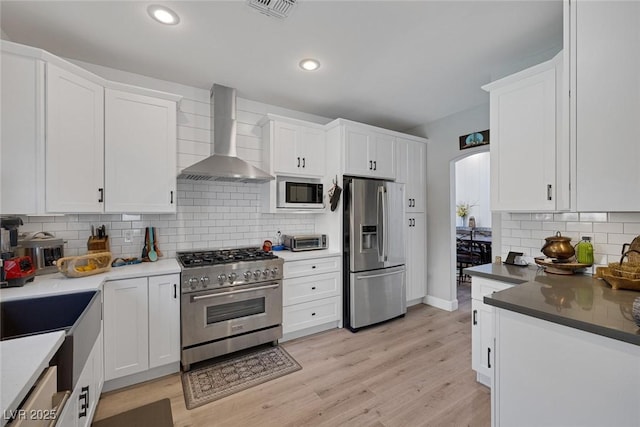 1246 Diamond Valley St, Henderson, NV 89052 - kitchen with stainless steel appliances, wall chimney range hood, backsplash, white cabinets, and recessed lighting
