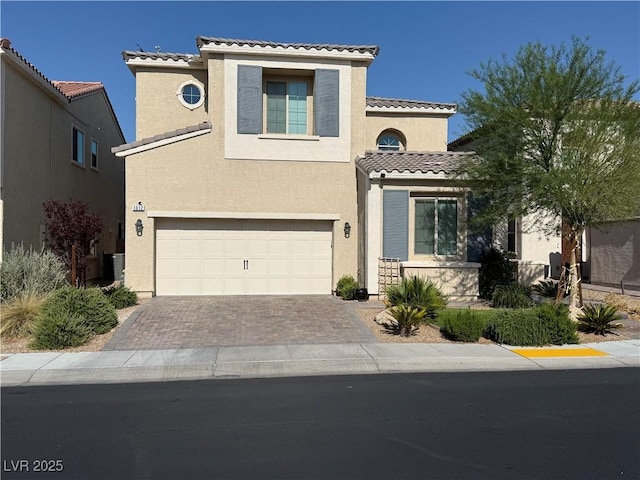 1012 Via Stellato St, Henderson, NV 89011 - mediterranean / spanish-style house with a tiled roof, stucco siding, an attached garage, and driveway