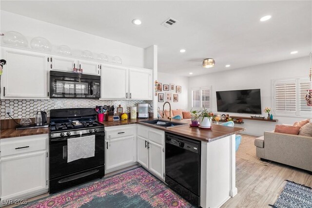 9105 Chenin Ave, Las Vegas, NV 89129 - kitchen with black appliances, open floor plan, a peninsula, butcher block countertops, and recessed lighting