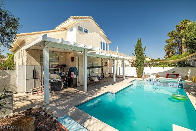9105 Chenin Ave, Las Vegas, NV 89129 - back of house featuring a pergola, a fenced backyard, a pool with connected hot tub, a patio, and stucco siding