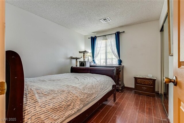3877 Platis Cir, Las Vegas, NV 89103 - bedroom with a textured ceiling and wood finished floors