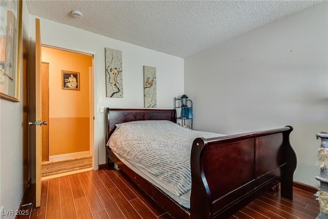 3877 Platis Cir, Las Vegas, NV 89103 - bedroom with wood finished floors and a textured ceiling