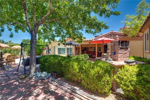 3877 Platis Cir, Las Vegas, NV 89103 - back of house featuring a patio, stucco siding, and a tile roof