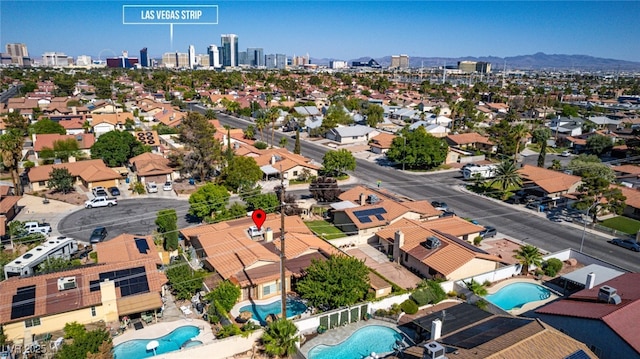 3877 Platis Cir, Las Vegas, NV 89103 - drone / aerial view of a pool and city skyline