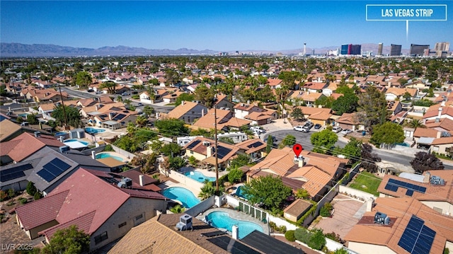3877 Platis Cir, Las Vegas, NV 89103 - aerial perspective of suburban area with a pool area and a mountainous background