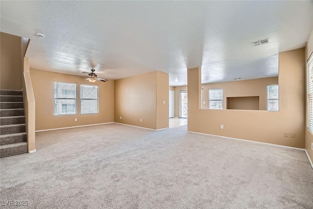 3141 Diamond Crest Ln, Henderson, NV 89052 - unfurnished living room with a ceiling fan, stairway, plenty of natural light, and carpet