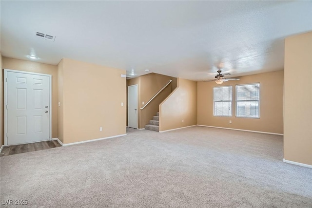 3141 Diamond Crest Ln, Henderson, NV 89052 - unfurnished living room with stairway, carpet floors, and ceiling fan