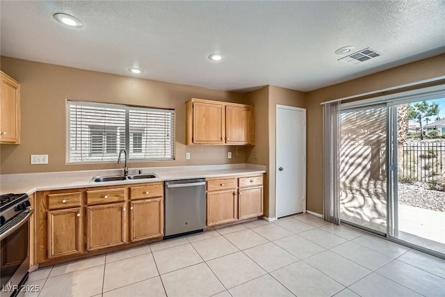 3141 Diamond Crest Ln, Henderson, NV 89052 - kitchen featuring appliances with stainless steel finishes, light countertops, a textured ceiling, recessed lighting, and light tile patterned flooring