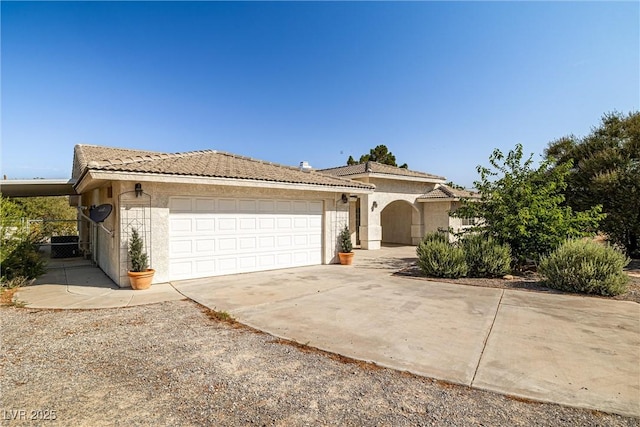 170 Dove St, Pahrump, NV 89060 - view of front facade with an attached garage, concrete driveway, and stucco siding