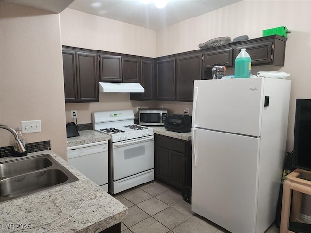 2110 Los Feliz St Unit 1096, Las Vegas, NV 89156 - kitchen featuring white appliances, under cabinet range hood, light countertops, and light tile patterned floors