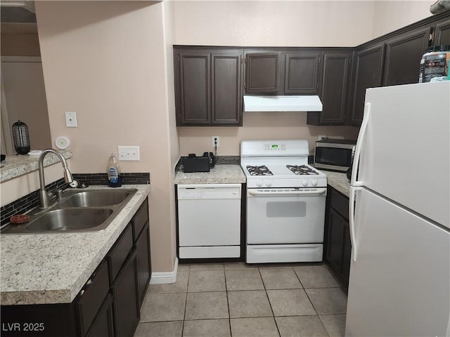 2110 Los Feliz St Unit 1096, Las Vegas, NV 89156 - kitchen with white appliances, under cabinet range hood, light tile patterned flooring, light countertops, and a peninsula
