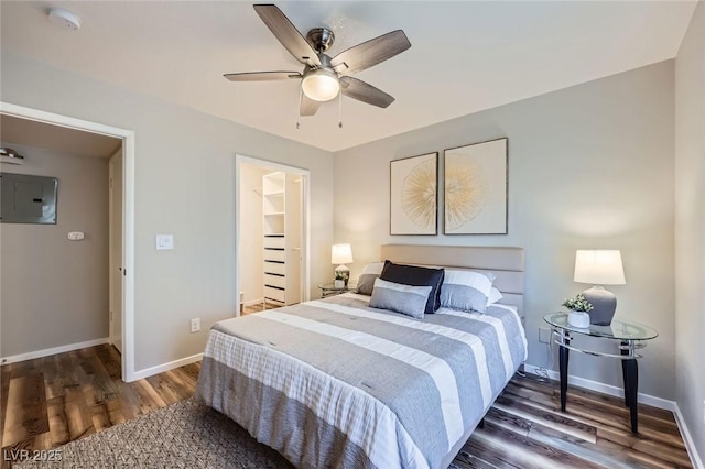 3125 N Buffalo Dr Unit 1133, Las Vegas, NV 89128 - bedroom featuring wood finished floors, electric panel, a spacious closet, and ceiling fan