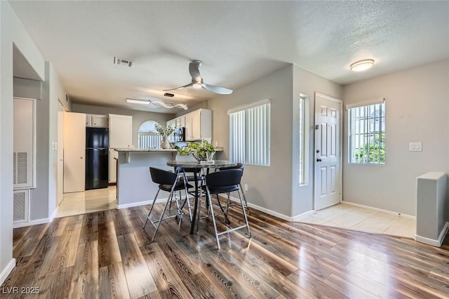3125 N Buffalo Dr Unit 1133, Las Vegas, NV 89128 - dining space featuring light wood-style flooring, a ceiling fan, and a textured ceiling