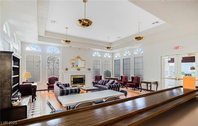 3125 N Buffalo Dr Unit 1133, Las Vegas, NV 89128 - living area with a raised ceiling, a glass covered fireplace, and french doors