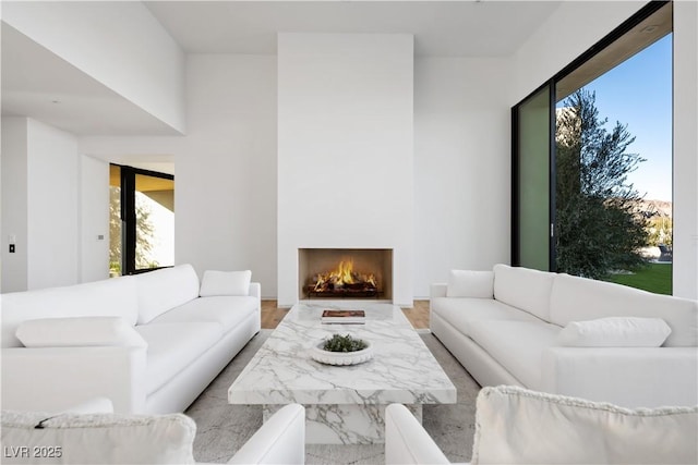 68 Sun Glow Ln, Las Vegas, NV 89135 - living room with healthy amount of natural light and a lit fireplace