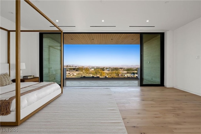 68 Sun Glow Ln, Las Vegas, NV 89135 - bedroom with floor to ceiling windows, wood finished floors, recessed lighting, and a mountain view
