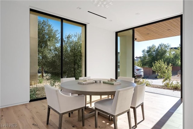 68 Sun Glow Ln, Las Vegas, NV 89135 - dining space featuring floor to ceiling windows, light wood finished floors, healthy amount of natural light, and a chandelier