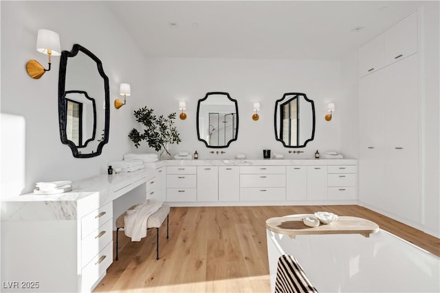 68 Sun Glow Ln, Las Vegas, NV 89135 - bathroom featuring wood finished floors, double vanity, and a tub to relax in