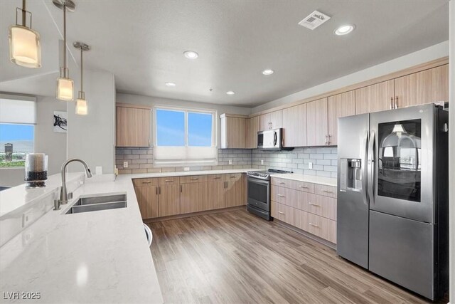 8255 Las Vegas Blvd Unit 722, Las Vegas, NV 89123 - kitchen featuring stainless steel appliances, light brown cabinets, light wood-type flooring, backsplash, and recessed lighting
