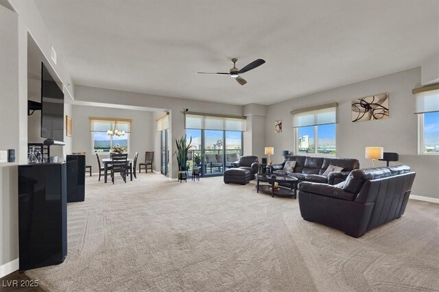 8255 Las Vegas Blvd Unit 722, Las Vegas, NV 89123 - carpeted living room with healthy amount of natural light, a ceiling fan, and a chandelier