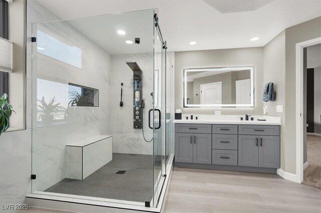 8255 Las Vegas Blvd Unit 722, Las Vegas, NV 89123 - full bathroom with double vanity, a shower stall, wood finished floors, and recessed lighting