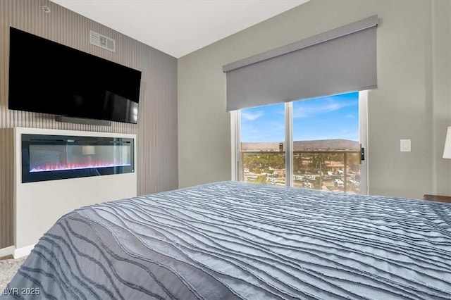 8255 Las Vegas Blvd Unit 722, Las Vegas, NV 89123 - bedroom with a glass covered fireplace and an accent wall