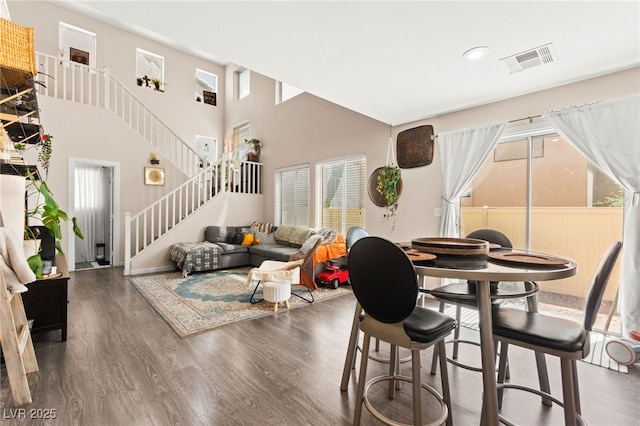 5674 Moccasin Point St, Las Vegas, NV 89148 - dining space with healthy amount of natural light, stairs, wood finished floors, a high ceiling, and recessed lighting