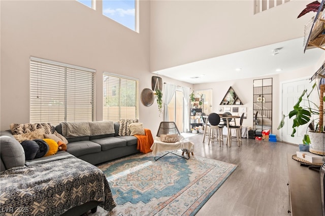 5674 Moccasin Point St, Las Vegas, NV 89148 - living area featuring wood finished floors, plenty of natural light, and a high ceiling
