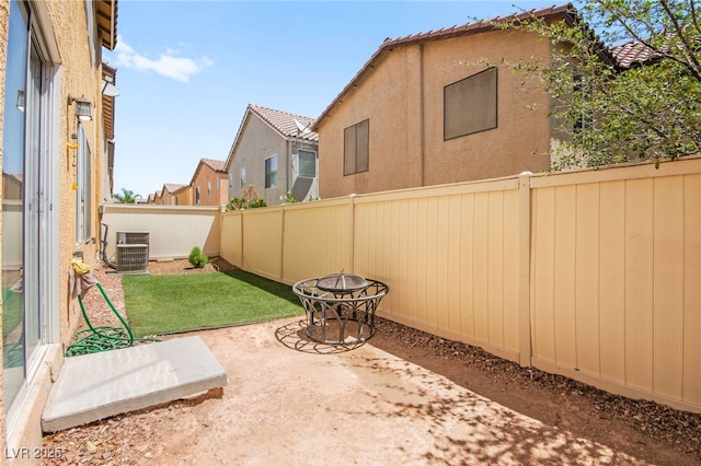 5674 Moccasin Point St, Las Vegas, NV 89148 - fenced backyard with a fire pit and a patio