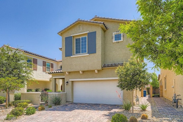 8048 Skye Bridge St, Las Vegas, NV 89166 - mediterranean / spanish-style home with an attached garage, a tiled roof, stucco siding, and decorative driveway