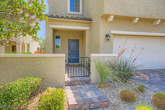8048 Skye Bridge St, Las Vegas, NV 89166 - view of exterior entry featuring stucco siding, an attached garage, and a gate