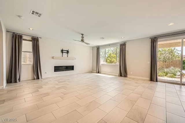 8048 Skye Bridge St, Las Vegas, NV 89166 - unfurnished living room featuring a ceiling fan, a glass covered fireplace, recessed lighting, and light tile patterned floors