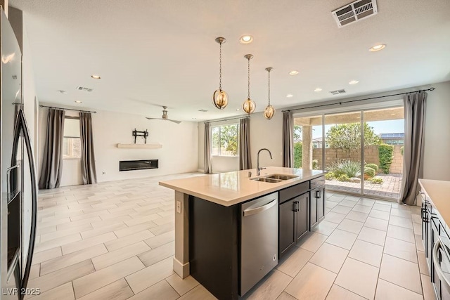 8048 Skye Bridge St, Las Vegas, NV 89166 - kitchen featuring dishwasher, open floor plan, recessed lighting, light countertops, and a center island with sink