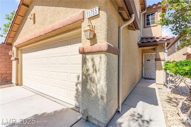 11755 Garland Grove Ln, Las Vegas, NV 89183 - view of side of property with stucco siding, driveway, and a tiled roof