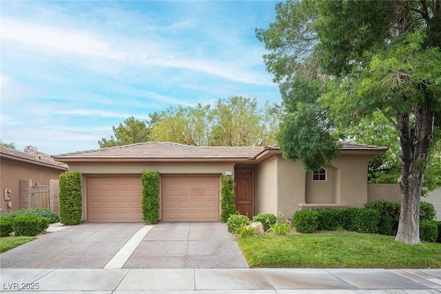 15 Emerald Dunes Cir, Henderson, NV 89052 - view of front facade with stucco siding, concrete driveway, a garage, a tiled roof, and a front lawn