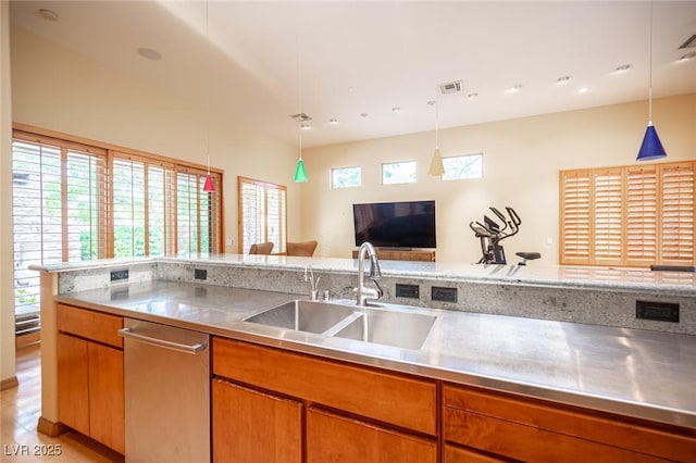 15 Emerald Dunes Cir, Henderson, NV 89052 - kitchen with stainless steel counters, dishwasher, hanging light fixtures, and brown cabinetry