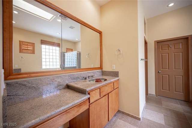 15 Emerald Dunes Cir, Henderson, NV 89052 - full bath featuring vanity, tile patterned flooring, a skylight, and recessed lighting