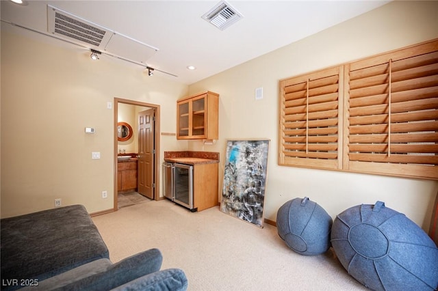 15 Emerald Dunes Cir, Henderson, NV 89052 - living area with rail lighting, light carpet, and beverage cooler