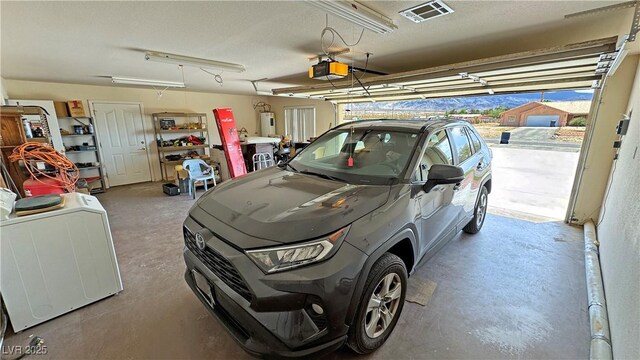 3110 National Ave, Pahrump, NV 89048 - garage with a garage door opener, washer and dryer, and water heater