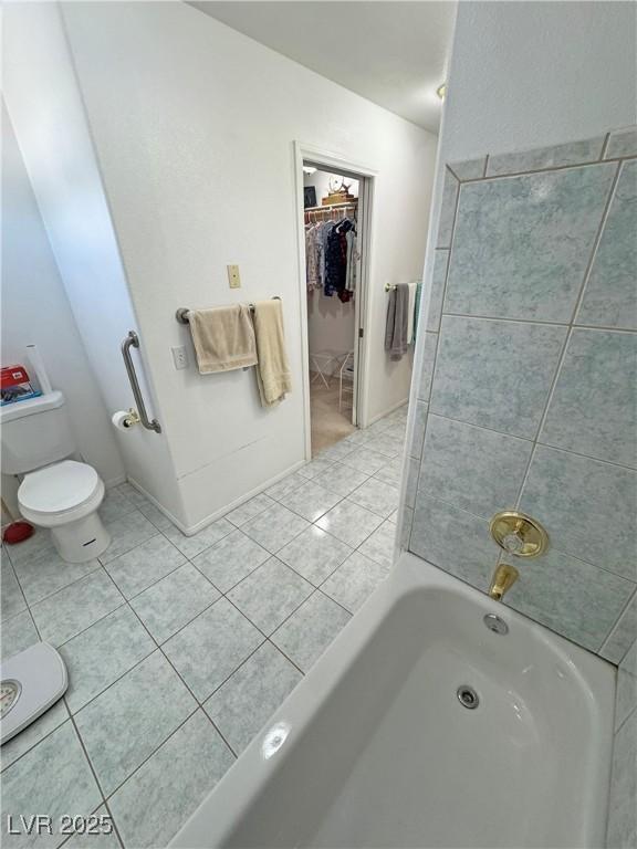 3110 National Ave, Pahrump, NV 89048 - bathroom with a bathtub, tile patterned flooring, and a walk in closet
