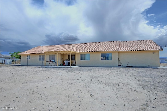 3110 National Ave, Pahrump, NV 89048 - rear view of house with stucco siding and a tiled roof
