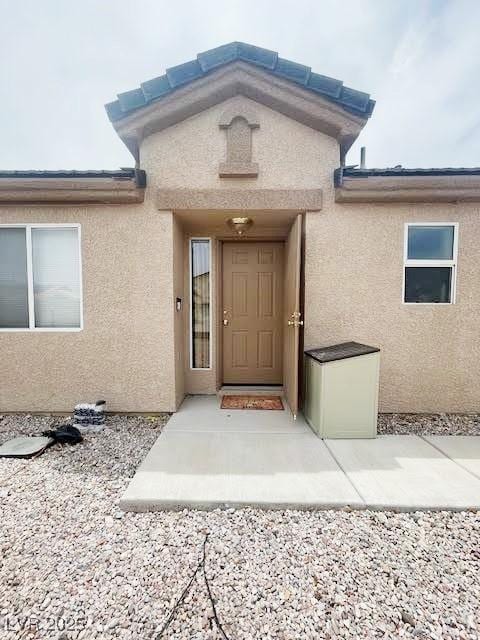 4314 Flaming Ridge Trl, Las Vegas, NV 89147 - doorway to property with stucco siding