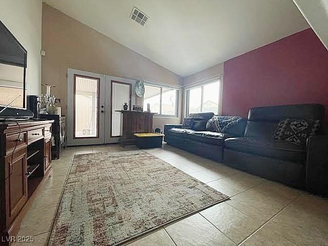 4314 Flaming Ridge Trl, Las Vegas, NV 89147 - living room featuring vaulted ceiling, light tile patterned floors, and french doors